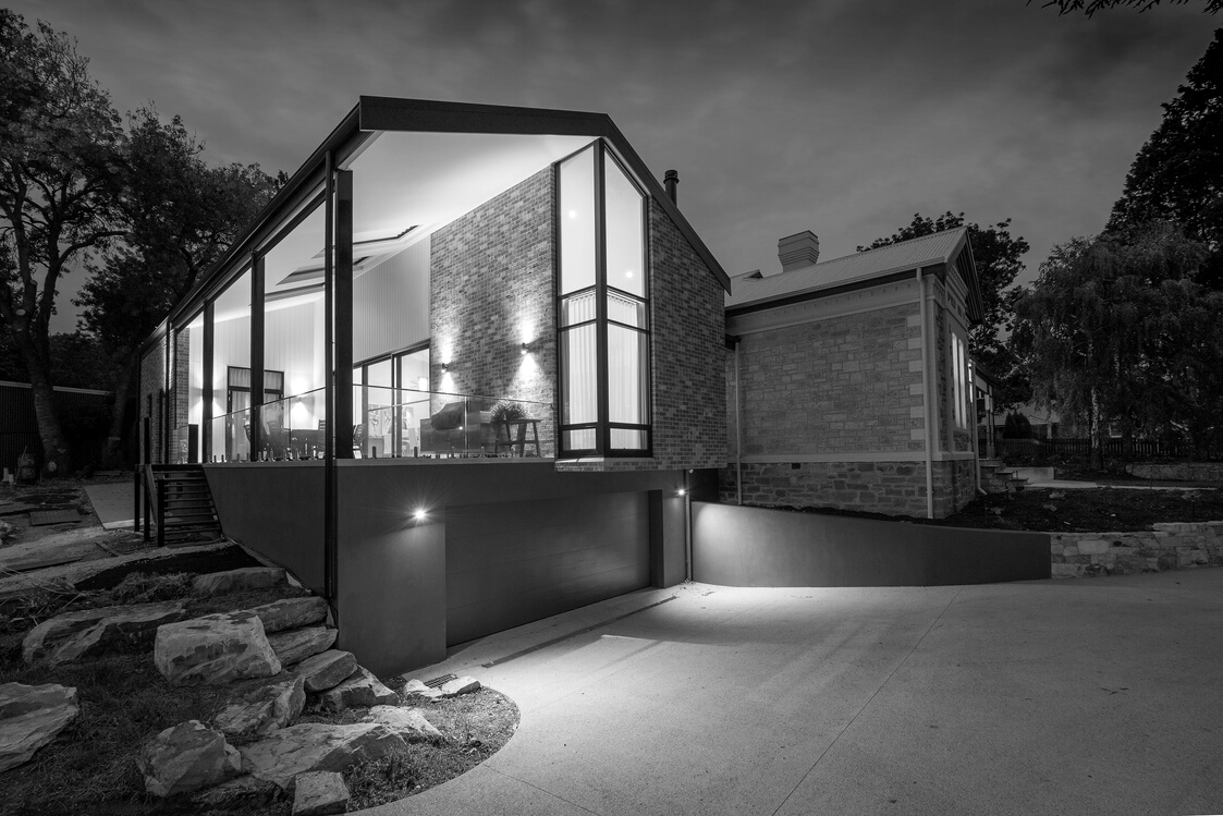 Modern house facade with glowing lights at dusk